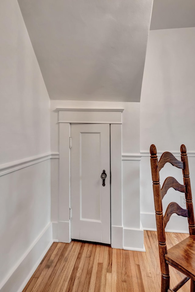 foyer with lofted ceiling and light hardwood / wood-style flooring