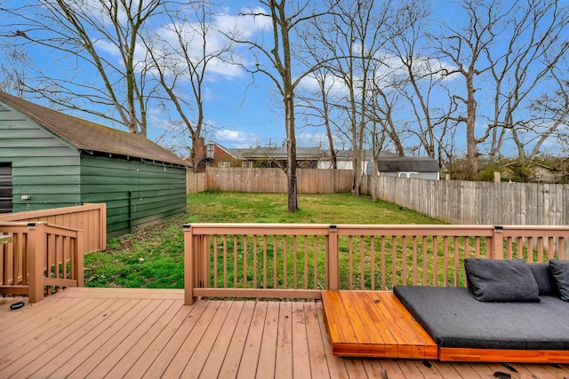 wooden terrace featuring a yard