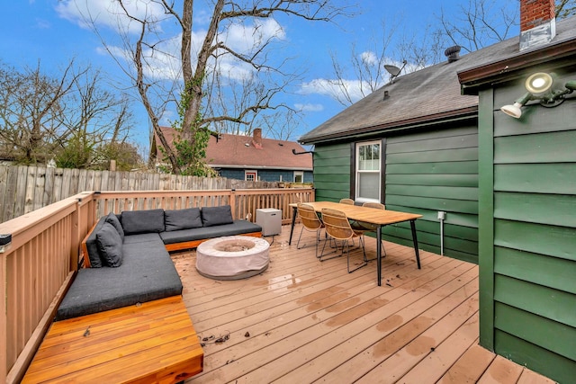 deck featuring an outdoor living space with a fire pit