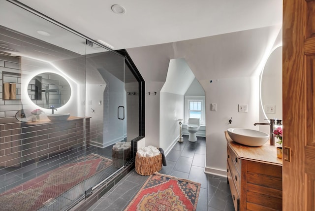 bathroom featuring vanity, a shower with shower door, tile patterned floors, and toilet