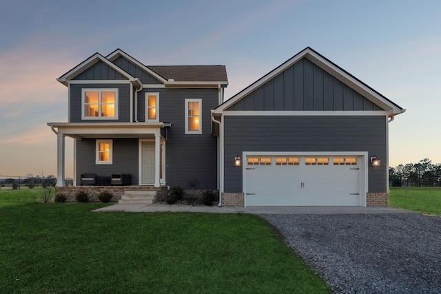 craftsman-style house with a garage, covered porch, and a lawn