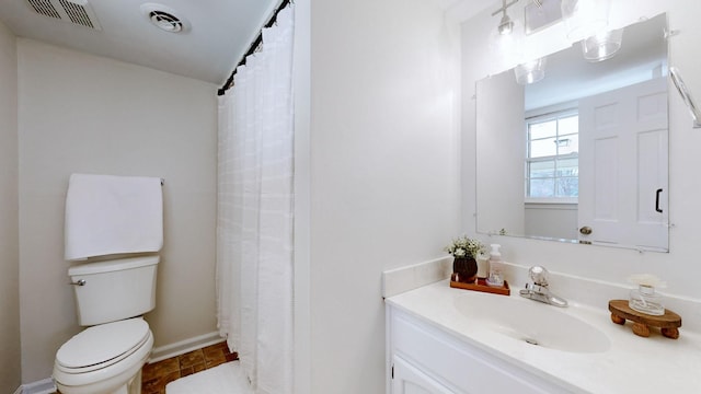 bathroom featuring vanity, tile patterned floors, and toilet