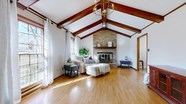 living room featuring vaulted ceiling with beams, a wealth of natural light, a notable chandelier, and light hardwood / wood-style flooring