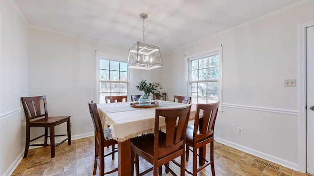 dining room featuring crown molding