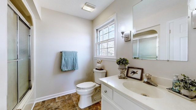 full bathroom with bath / shower combo with glass door, vanity, and toilet