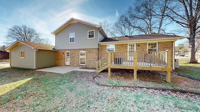 rear view of property with a wooden deck, a yard, central AC unit, and a patio area