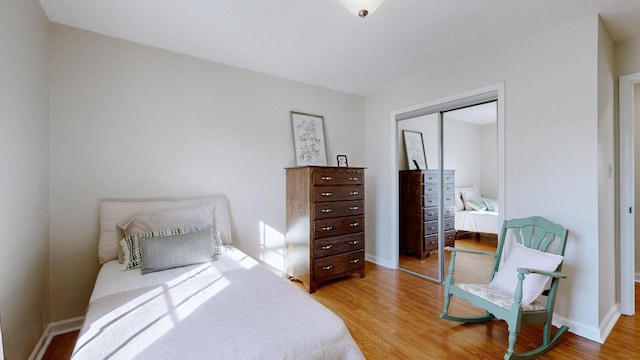 bedroom with hardwood / wood-style floors and a closet