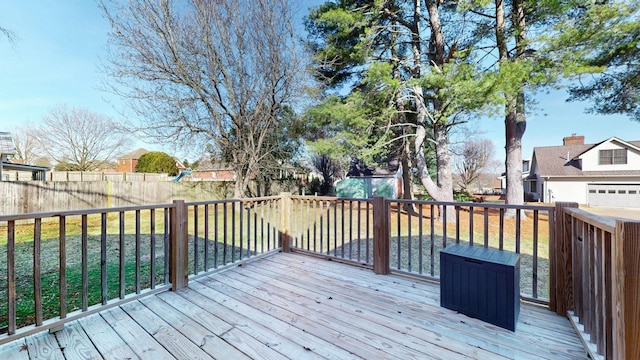 wooden terrace featuring a lawn