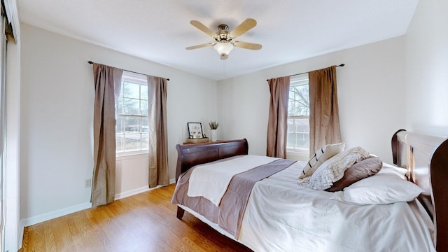 bedroom with ceiling fan and light wood-type flooring