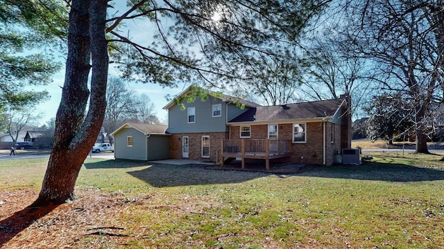 rear view of house featuring central AC, a yard, and a wooden deck