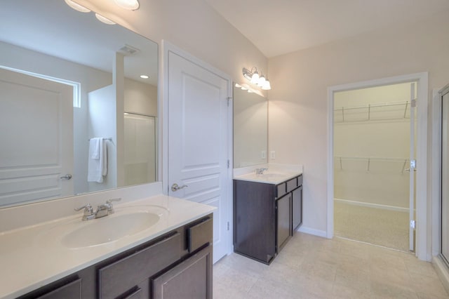 bathroom featuring vanity and an enclosed shower