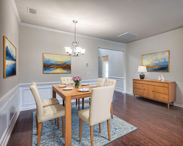 dining area with crown molding, dark wood-type flooring, and a chandelier