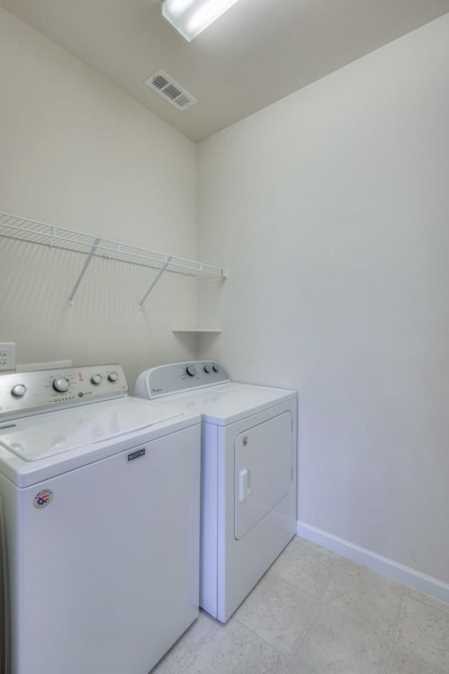 clothes washing area with washer and dryer