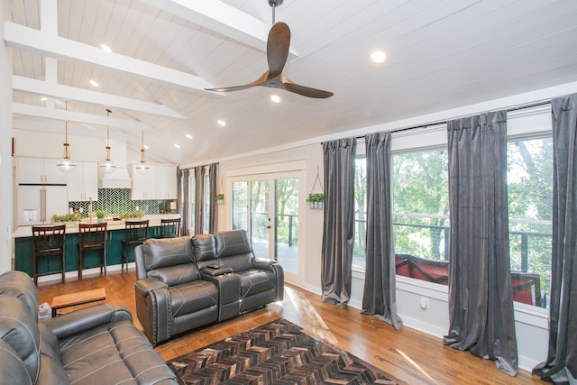 living room featuring vaulted ceiling with beams, hardwood / wood-style flooring, and ceiling fan