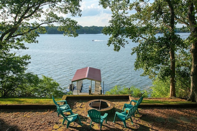 view of dock with a water view and an outdoor fire pit