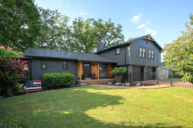 back of property featuring a garage and a lawn