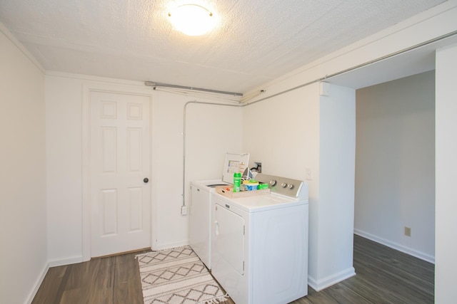 laundry room featuring washer and clothes dryer, dark hardwood / wood-style floors, and a textured ceiling