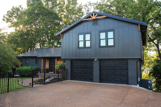 view of front of home featuring central AC unit and a garage