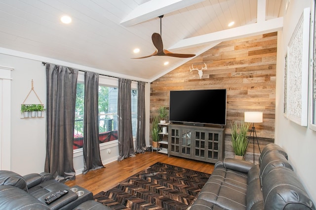 living room featuring dark hardwood / wood-style floors, wood walls, lofted ceiling with beams, wood ceiling, and ceiling fan