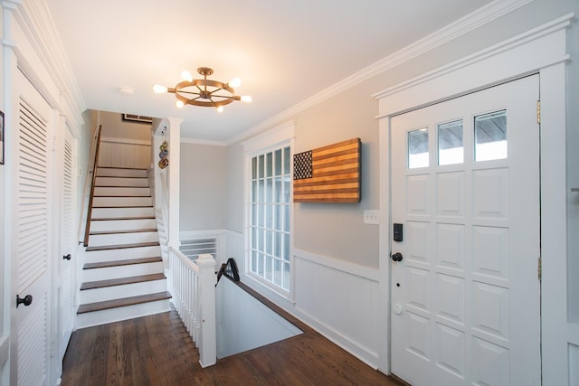 entryway with an inviting chandelier, crown molding, and dark hardwood / wood-style floors