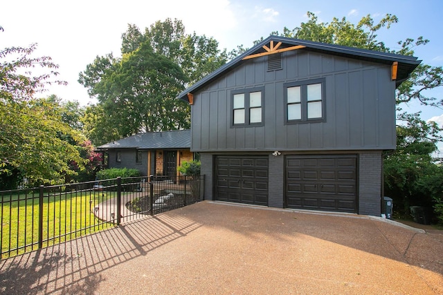 view of front of house with a garage and a front lawn