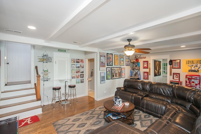 living room featuring beamed ceiling, ceiling fan, and hardwood / wood-style flooring