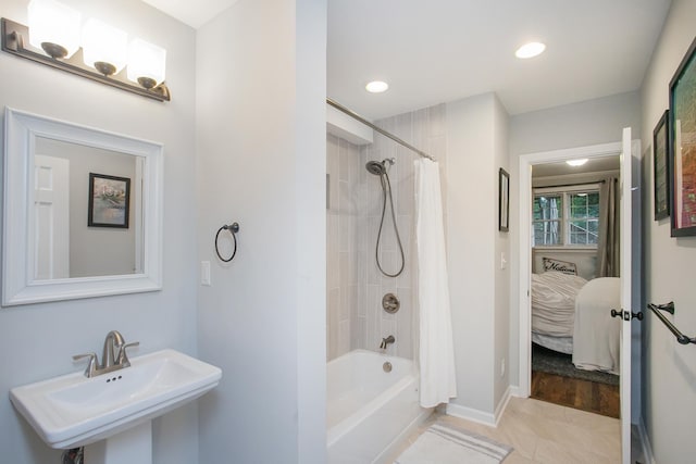 bathroom with sink, tile patterned floors, and shower / bath combo with shower curtain