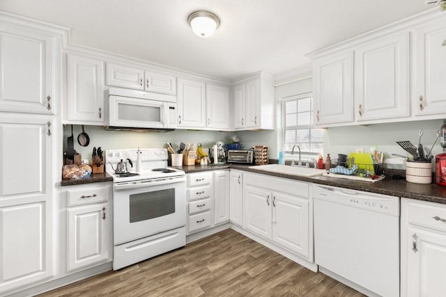 kitchen featuring white cabinetry, white appliances, sink, and hardwood / wood-style floors