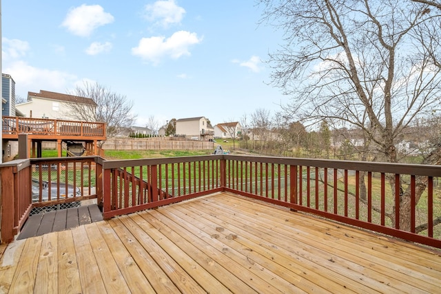 wooden terrace featuring a lawn