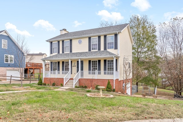 view of front of property with a garage, a front lawn, and a porch