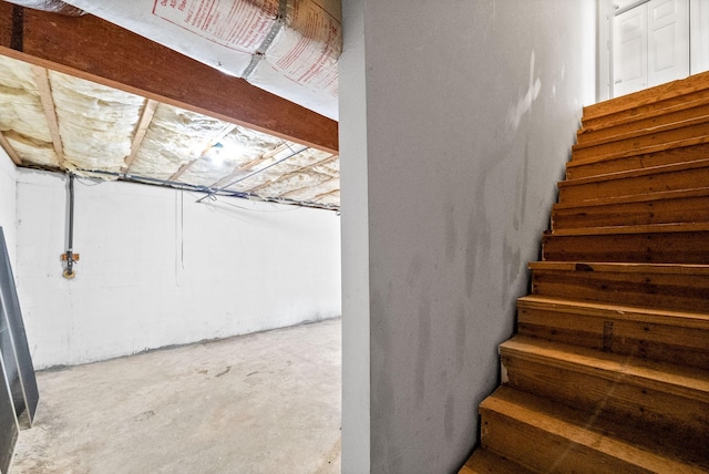 stairway with concrete flooring