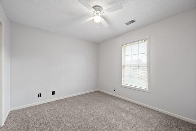 unfurnished room with a textured ceiling, ceiling fan, and carpet flooring