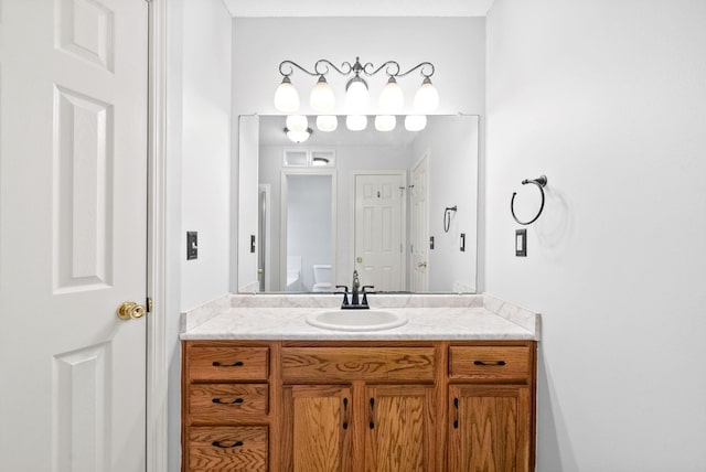 bathroom featuring vanity and toilet