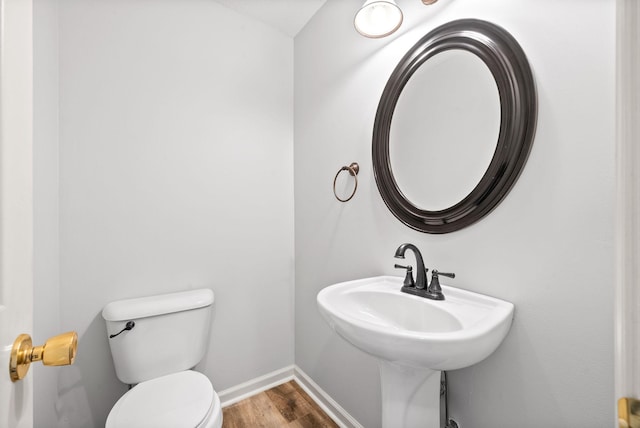 bathroom with sink, wood-type flooring, and toilet