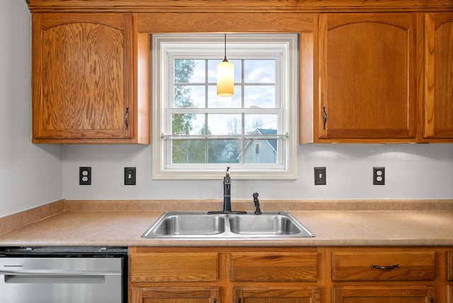 kitchen featuring dishwasher, sink, and hanging light fixtures