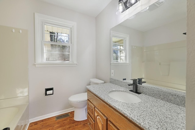 bathroom with vanity, hardwood / wood-style floors, and toilet