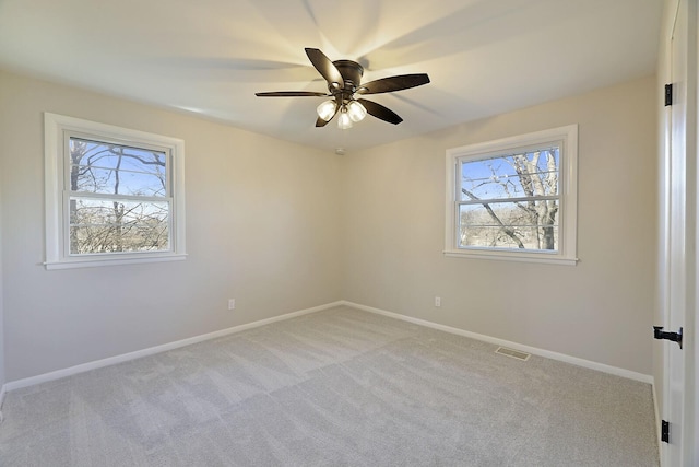 unfurnished room with ceiling fan and light colored carpet