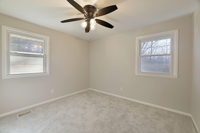 carpeted spare room featuring plenty of natural light