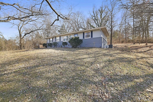 view of front of house featuring central AC and a front lawn