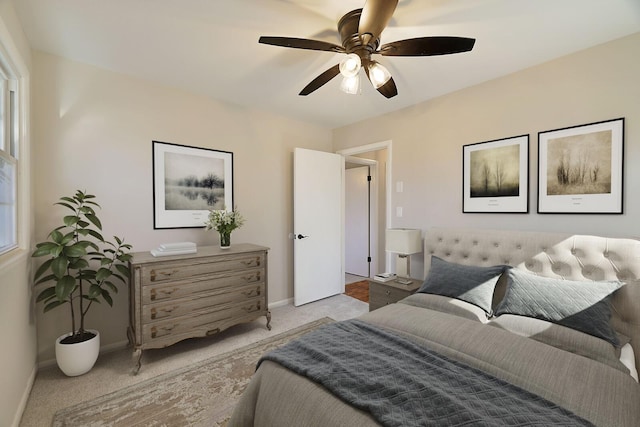 bedroom featuring ceiling fan and light carpet