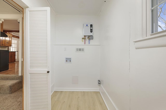 laundry area with hookup for a washing machine, ornamental molding, and light wood-type flooring