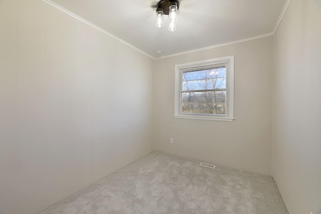 empty room with ornamental molding and light carpet