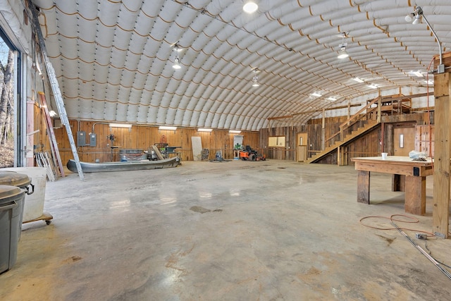 misc room with concrete flooring and vaulted ceiling