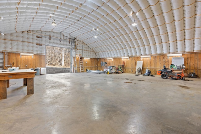 garage featuring a workshop area and wood walls