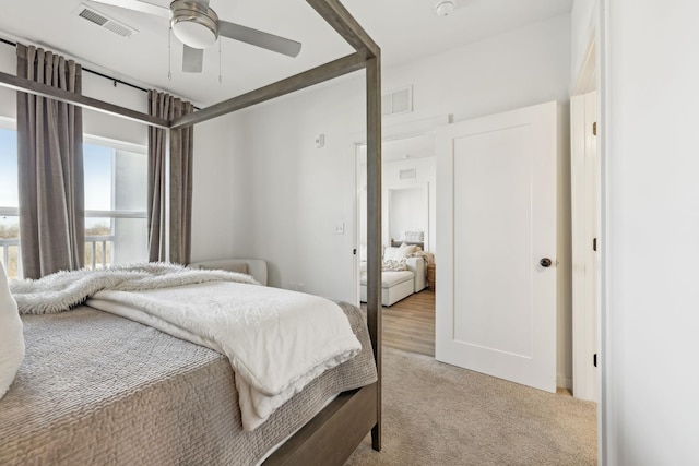 bedroom with light colored carpet and ceiling fan