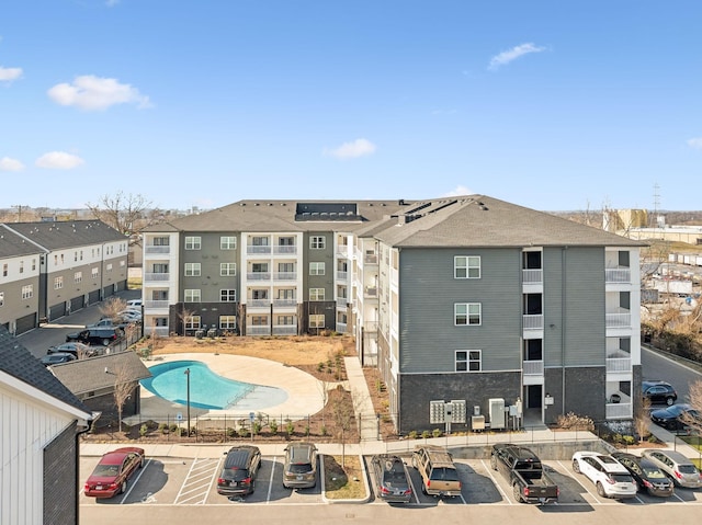 view of building exterior with a swimming pool