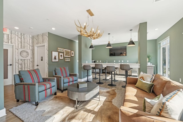 living room featuring an inviting chandelier and light hardwood / wood-style floors