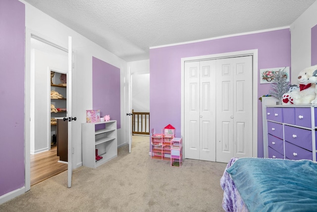 bedroom with light carpet, a closet, and a textured ceiling