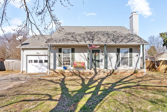 view of front of house featuring a garage, covered porch, and a front yard