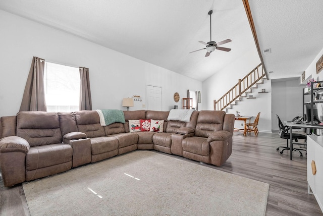 living room with wood-type flooring, vaulted ceiling, and ceiling fan